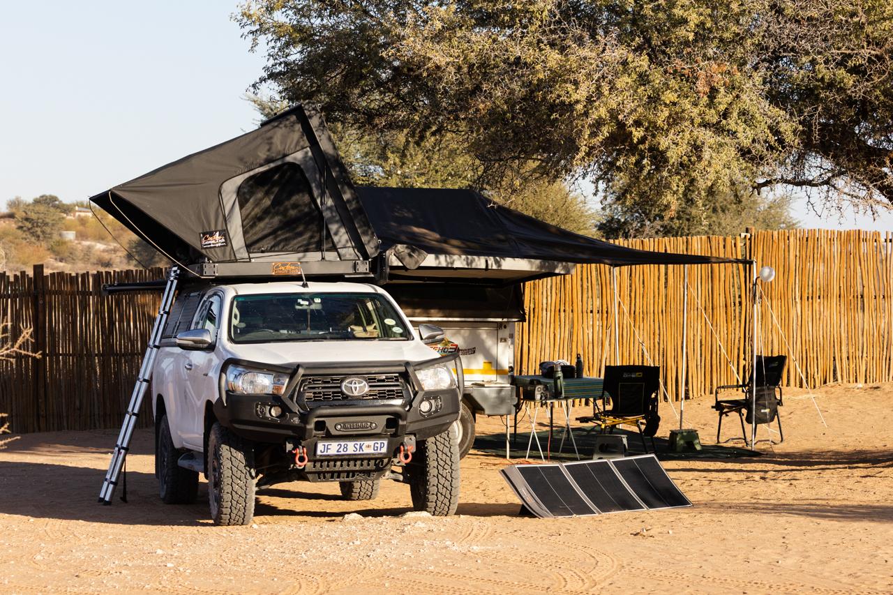 A rooftop tent camp at the edge of the wilderness
